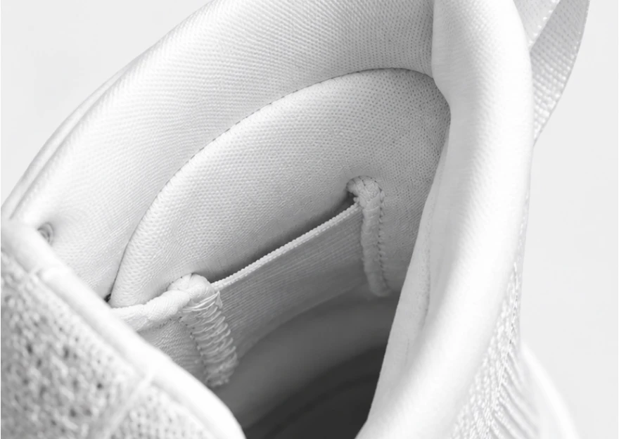 Shoe interior showing padded collar and white heel retention strap