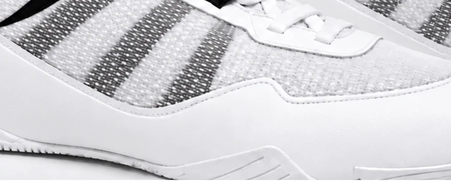 Close-up of white shoe mesh and visible support bands