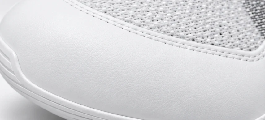 White leather toe guard meeting the mesh upper