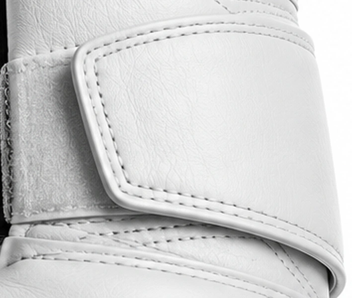 Close-up of the white leather Velcro strap, tonal double stitching and textured hook-and-loop fastening